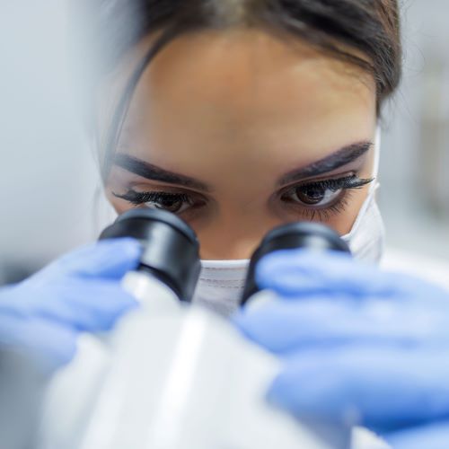 Young woman using a microscope